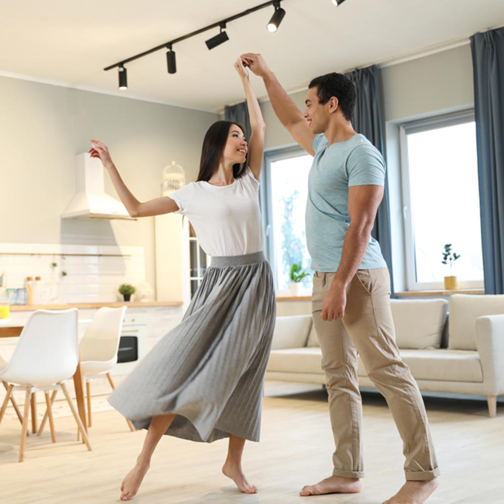 Lovely young couple dancing at home