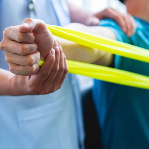 Physical therapist gives resistance band exercises