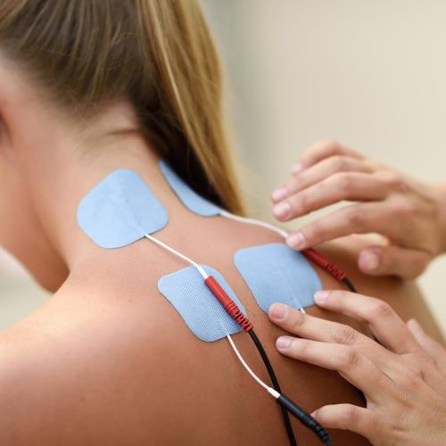 Electro stimulation in physical therapy to a young woman