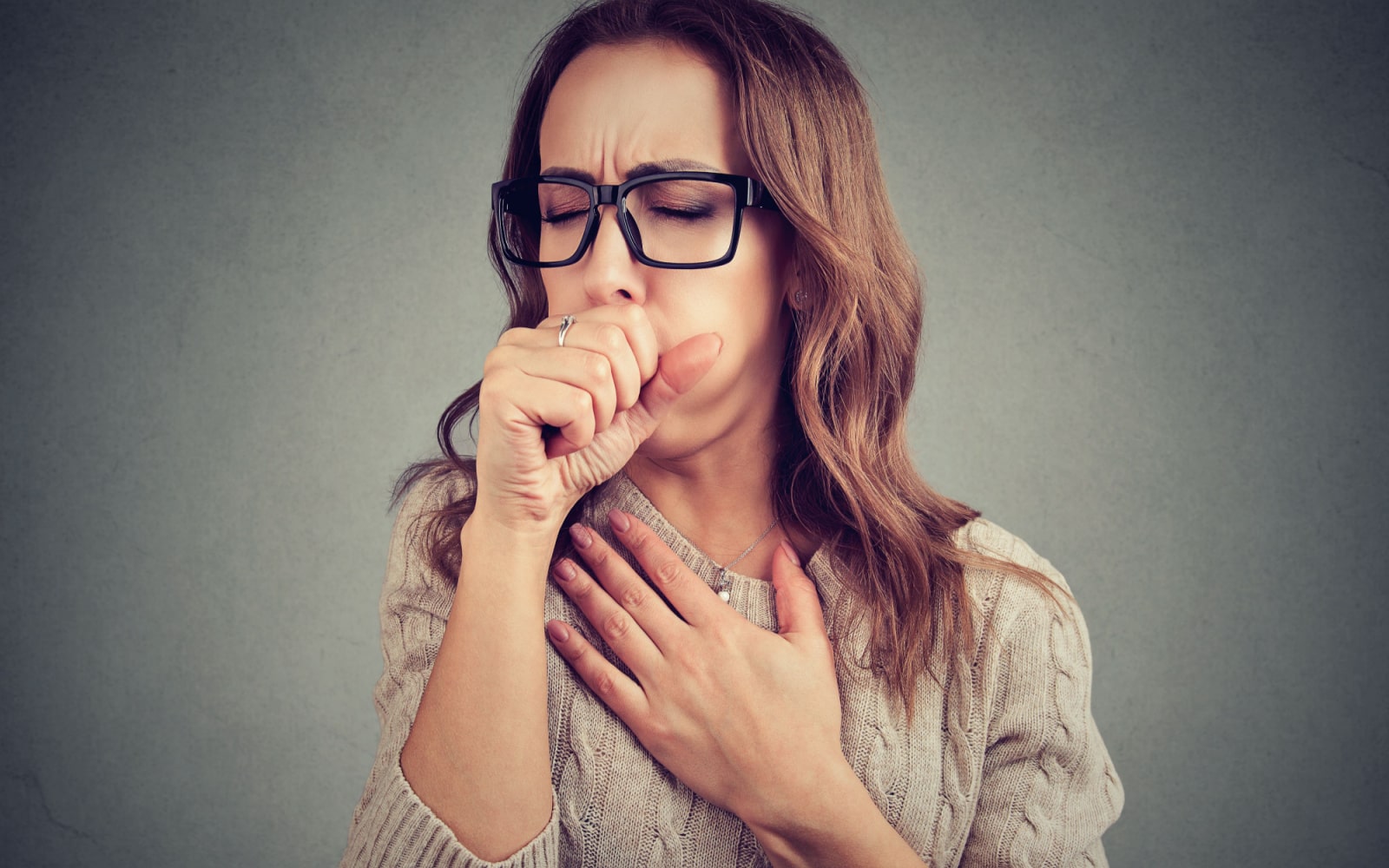 Woman Wearing Glasses Experiencing GERD and Coughing