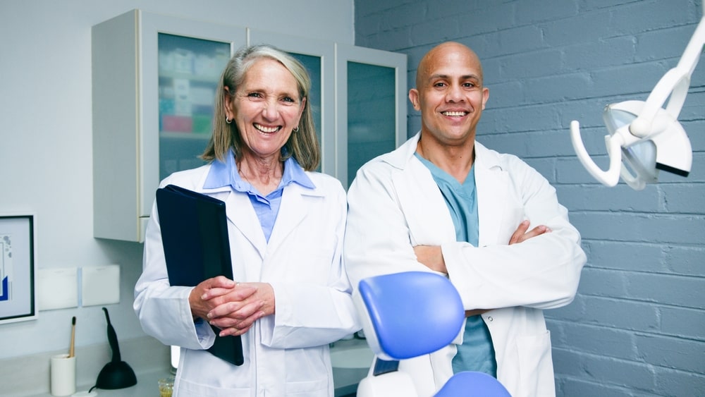 Two Confident Dentists Smiling in their Modern Clinic