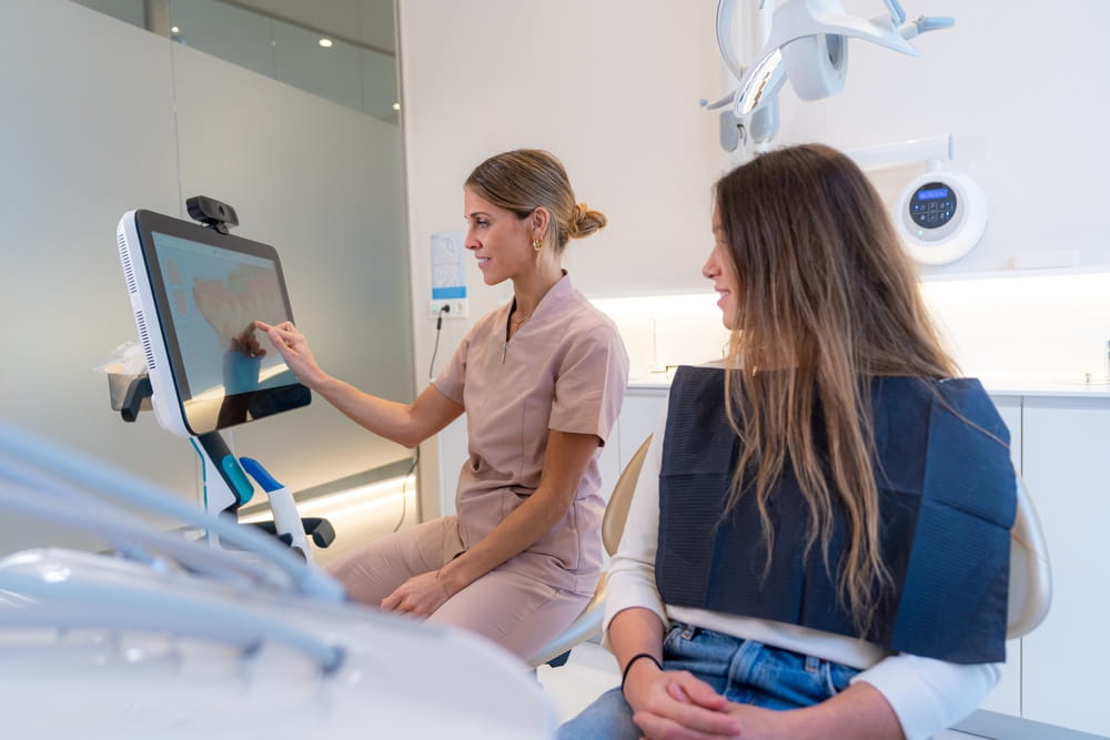 Dentist using modern technology to explain a dental procedure to a patient