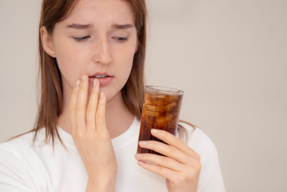 Concept of oral health problem, tooth decay, and effects of sugary drinks on teeth.