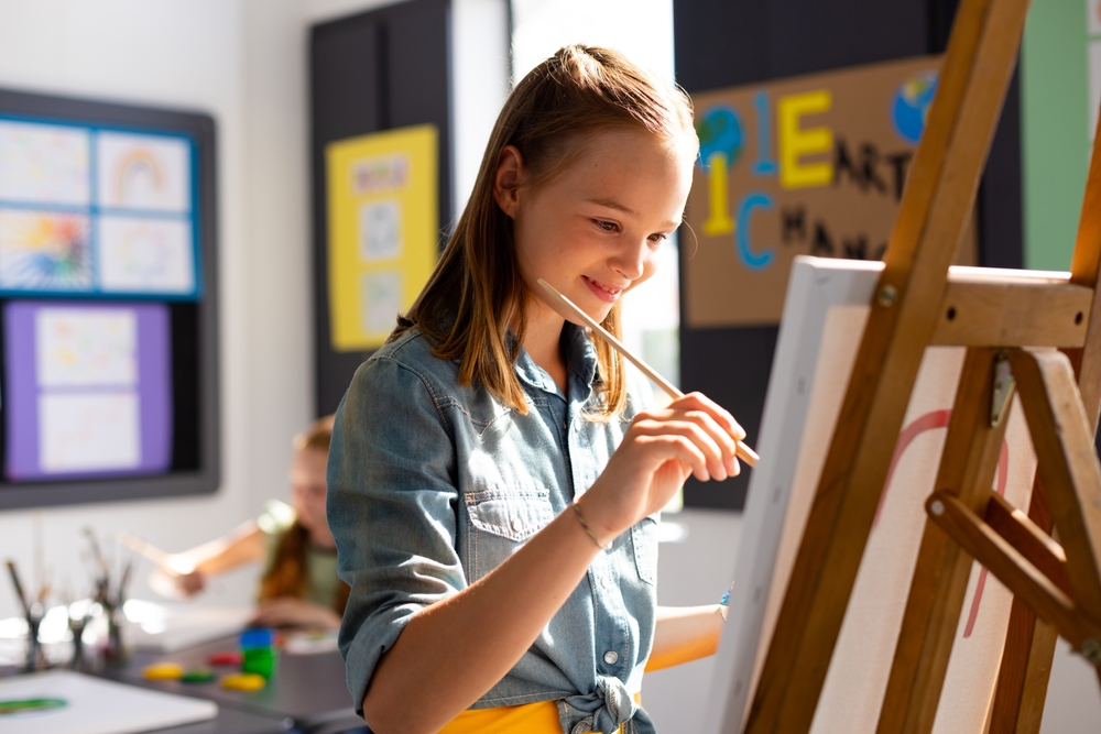 child painting on canvas
