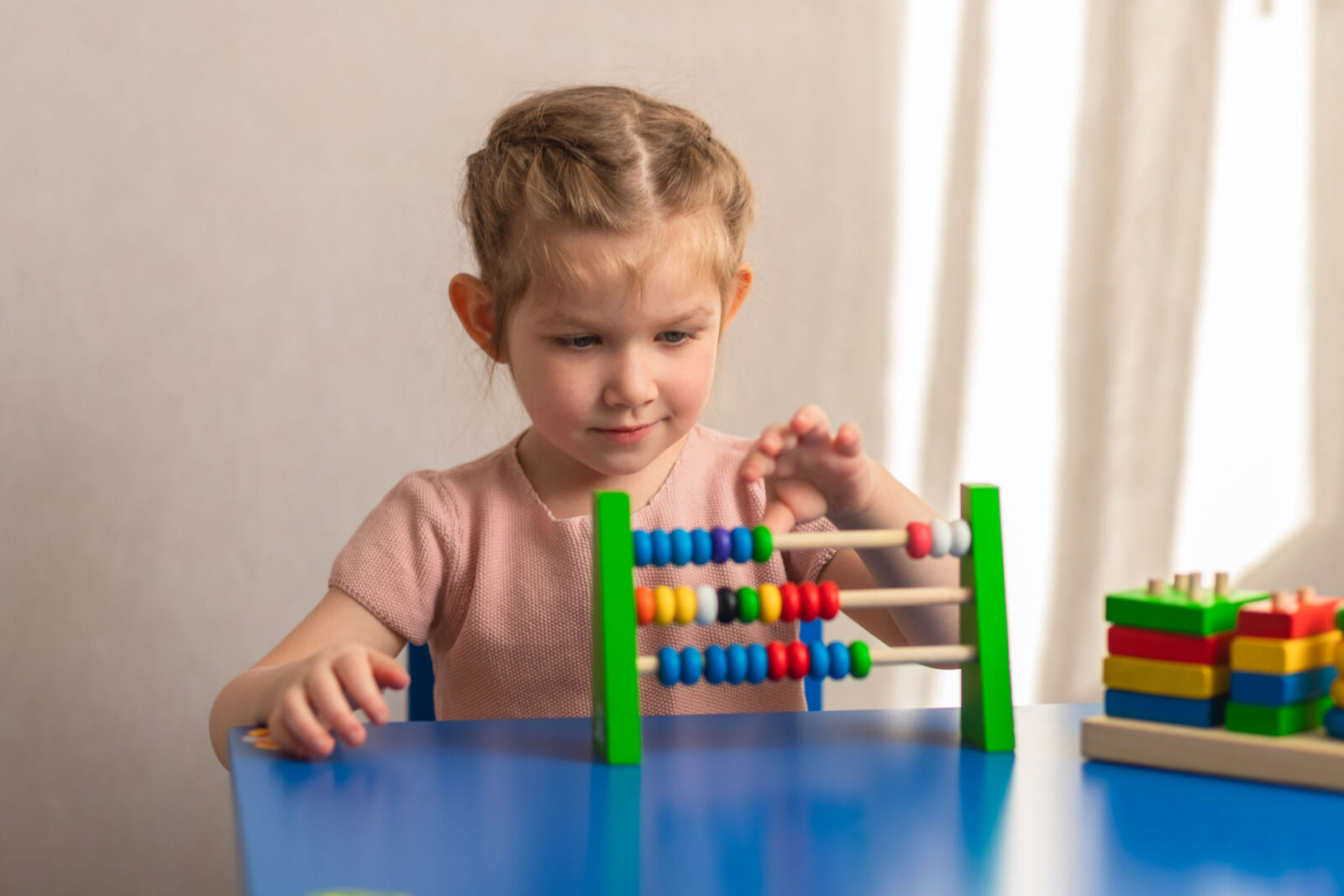 a child working on a puzzle, possibly has an autism spectrum disorder