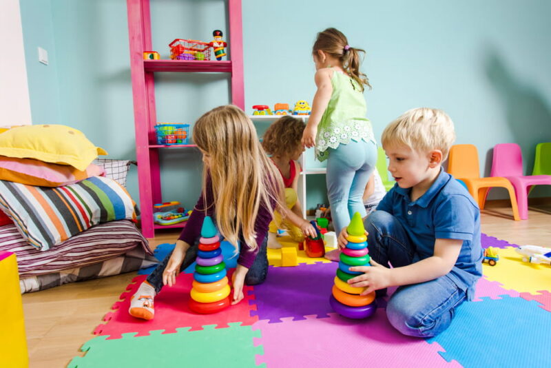 Kids playing together on a colorful mats
