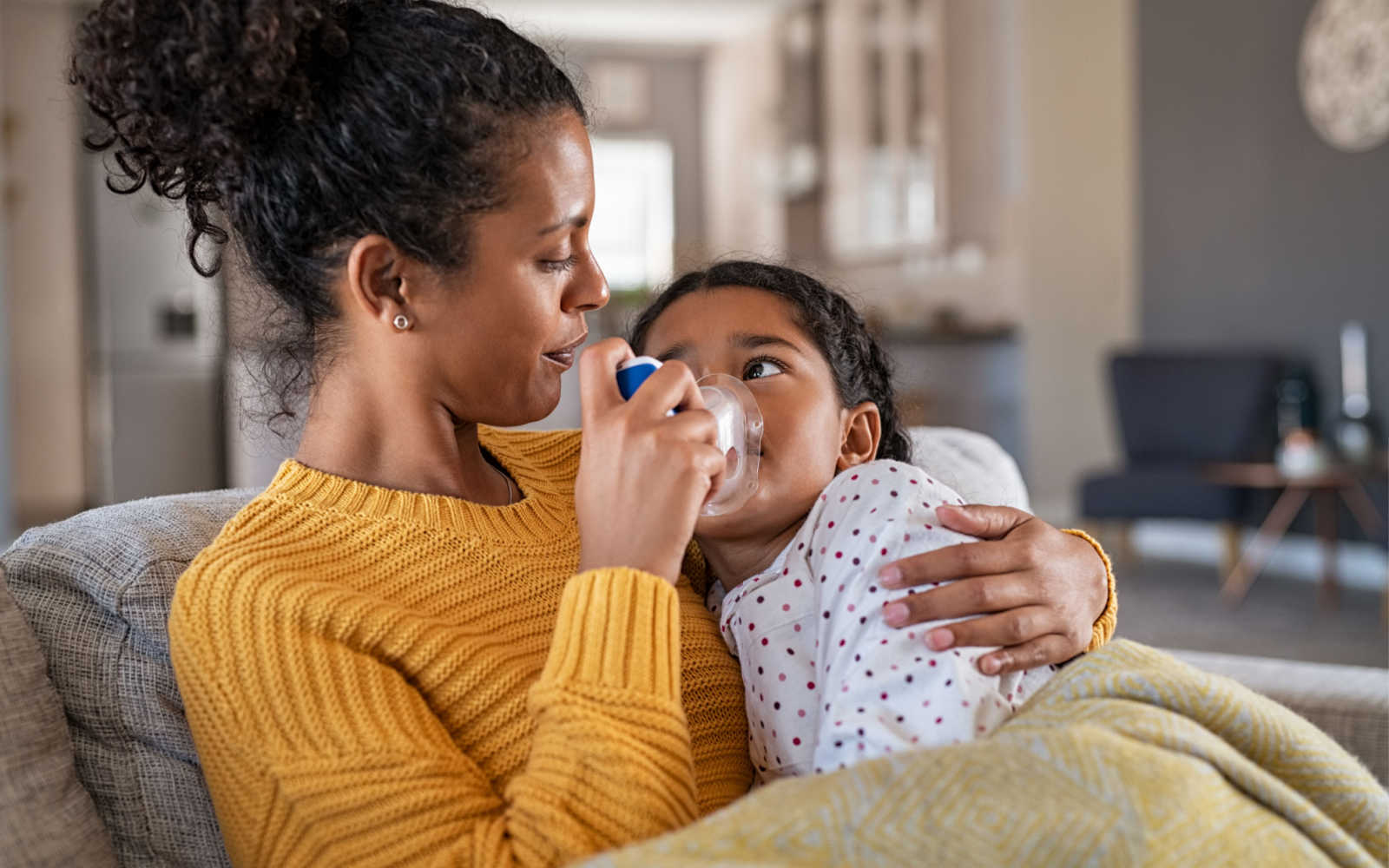 Woman Caring For Her Child with Asthma Inhaler