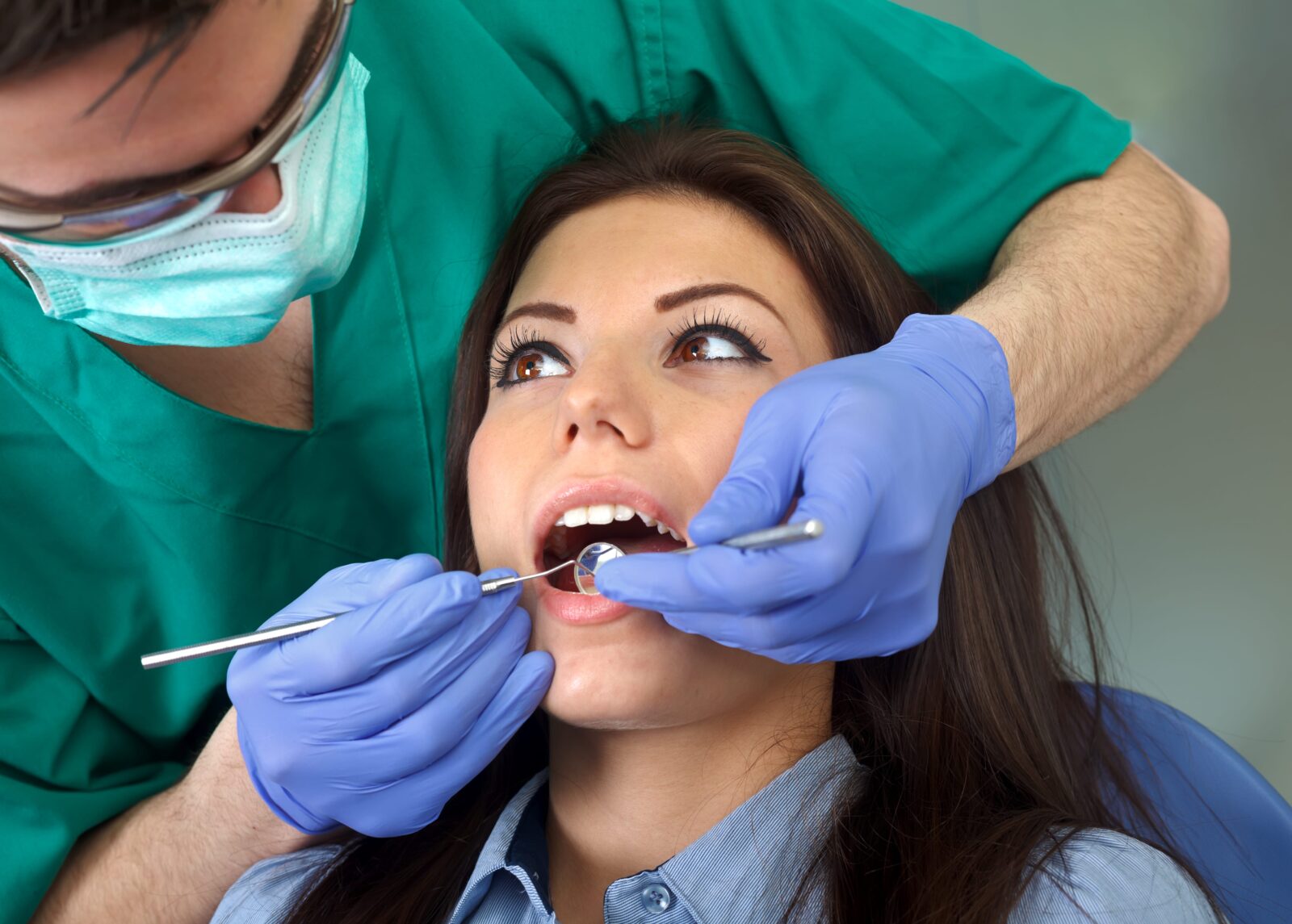 woman having her teeth examined by a dentist