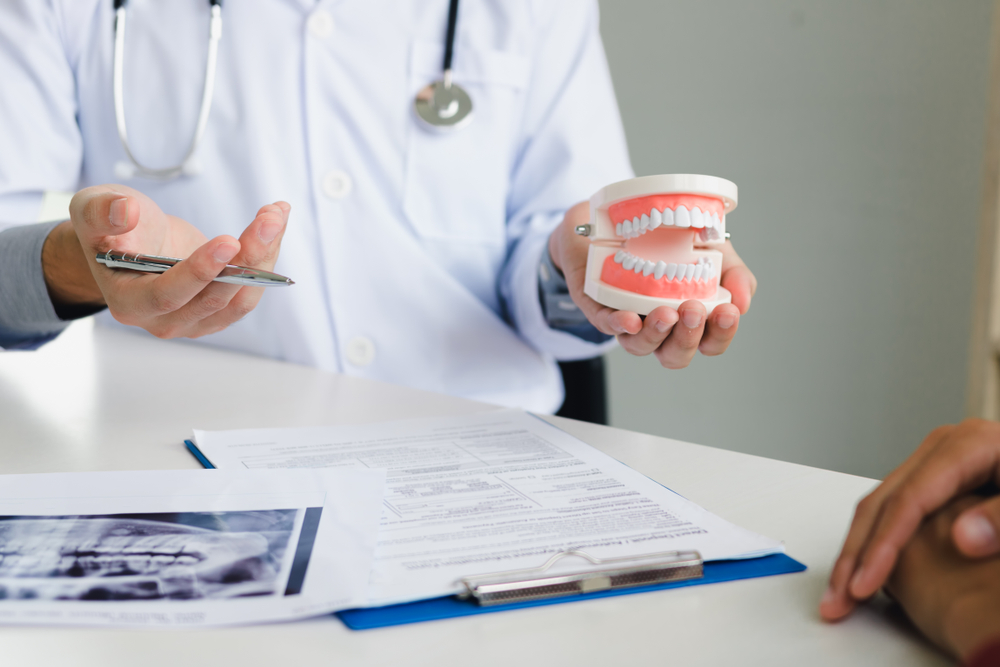 A dentist explaining to a patient the best practices for Prevention in Dental Care