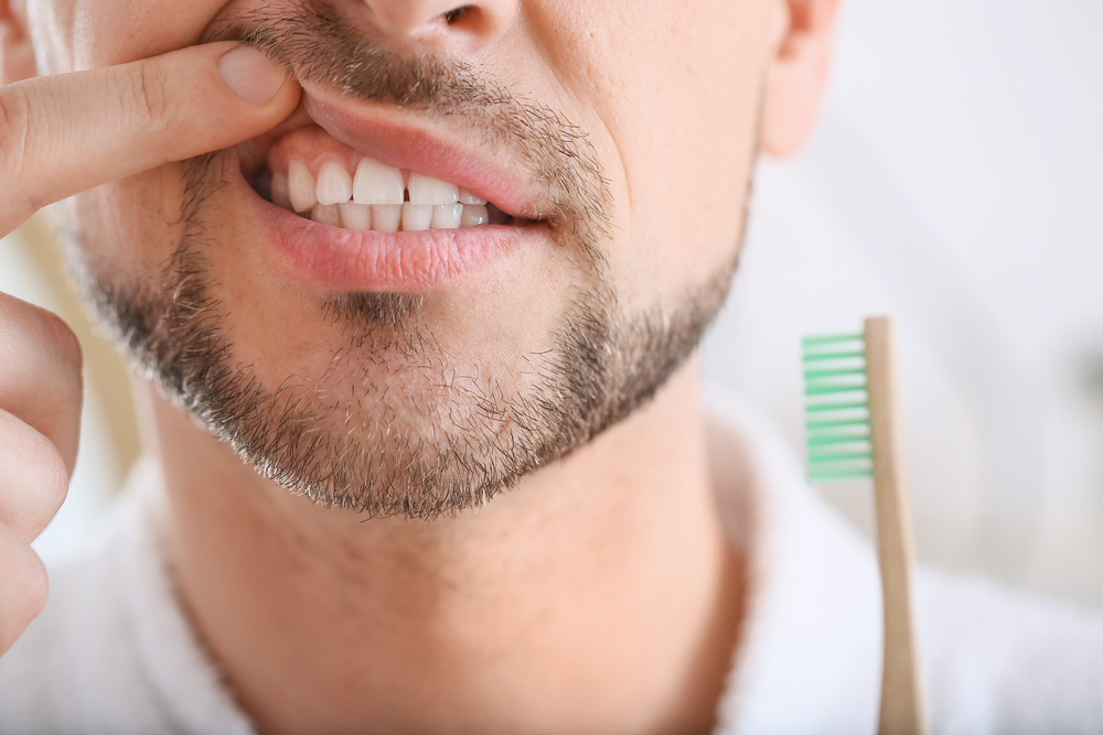 A man checking his gums for Gum Disease 
