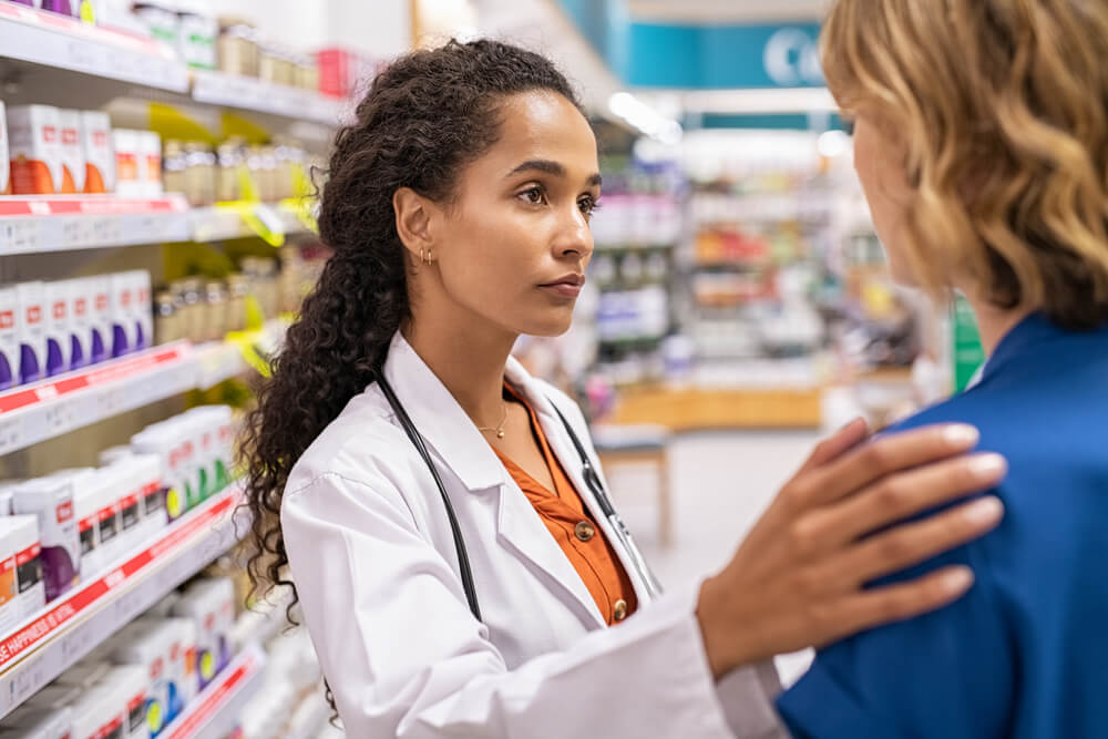 Pharmacist and customer talking about medication