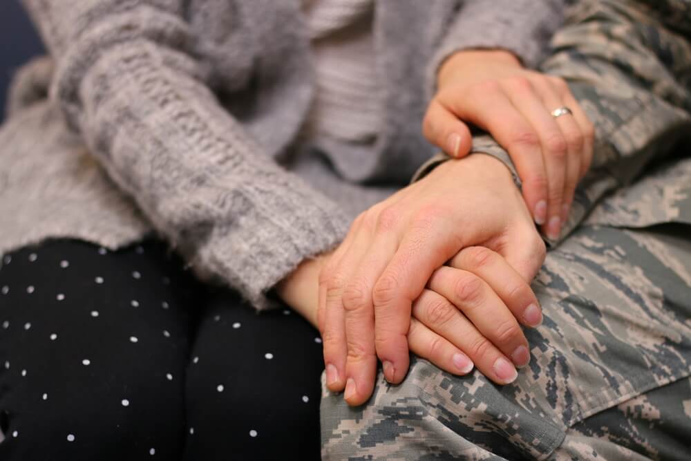 Military couple holding hands