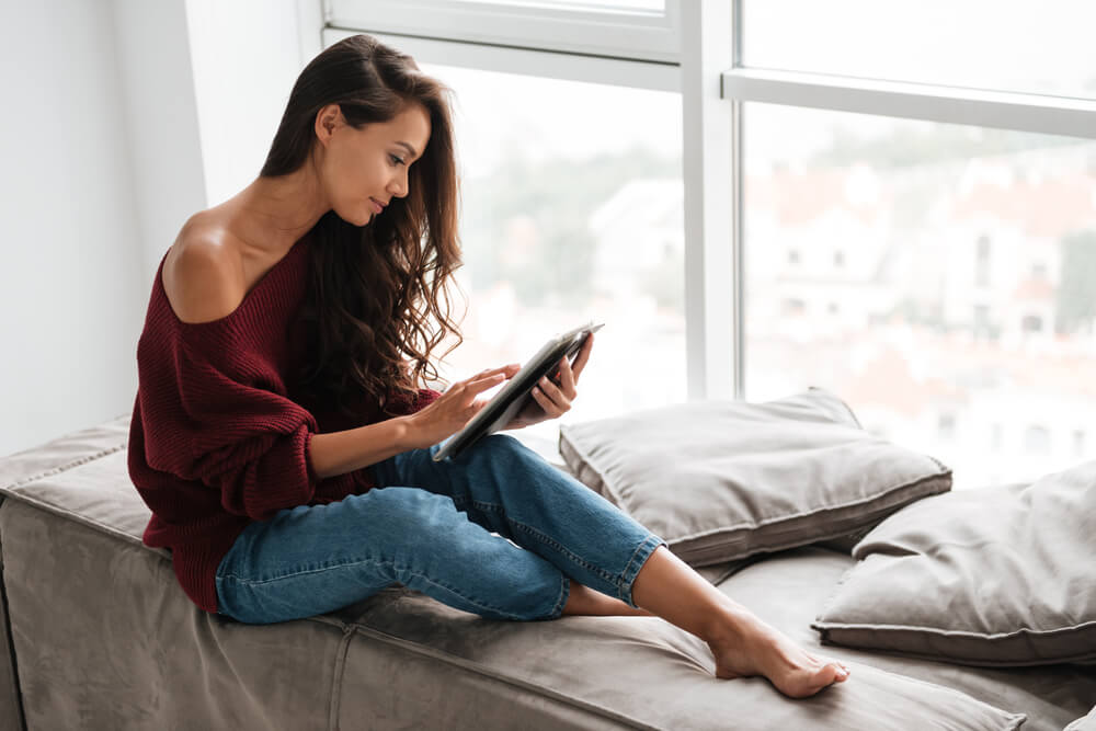 pretty woman using tablet computer at home