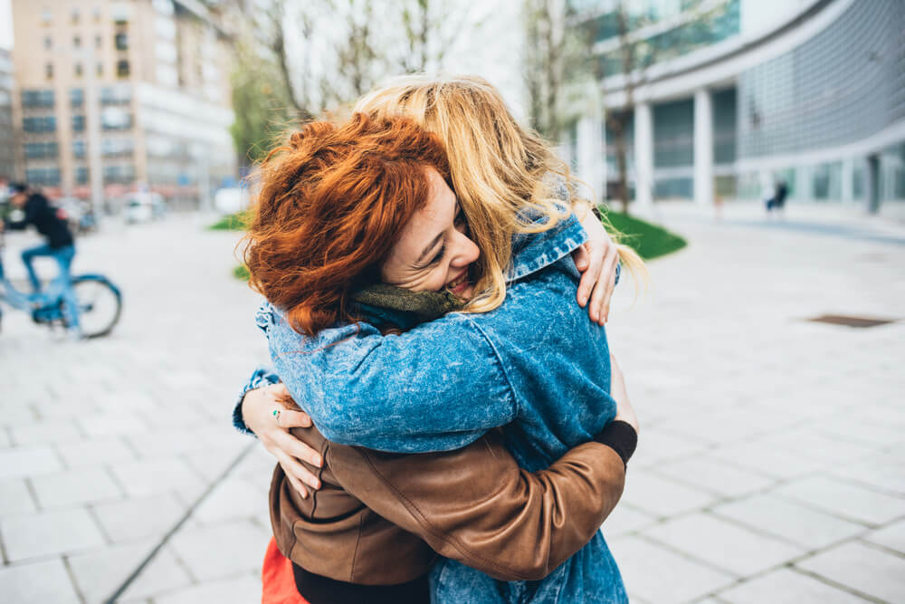 Two friends meeting in the street of the city