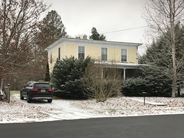 yellow house in winter upstate NY