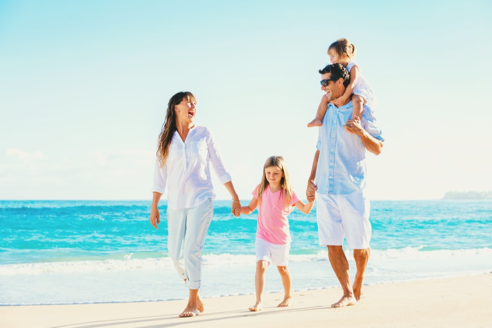 Happy Family Having Fun Walking on Beach