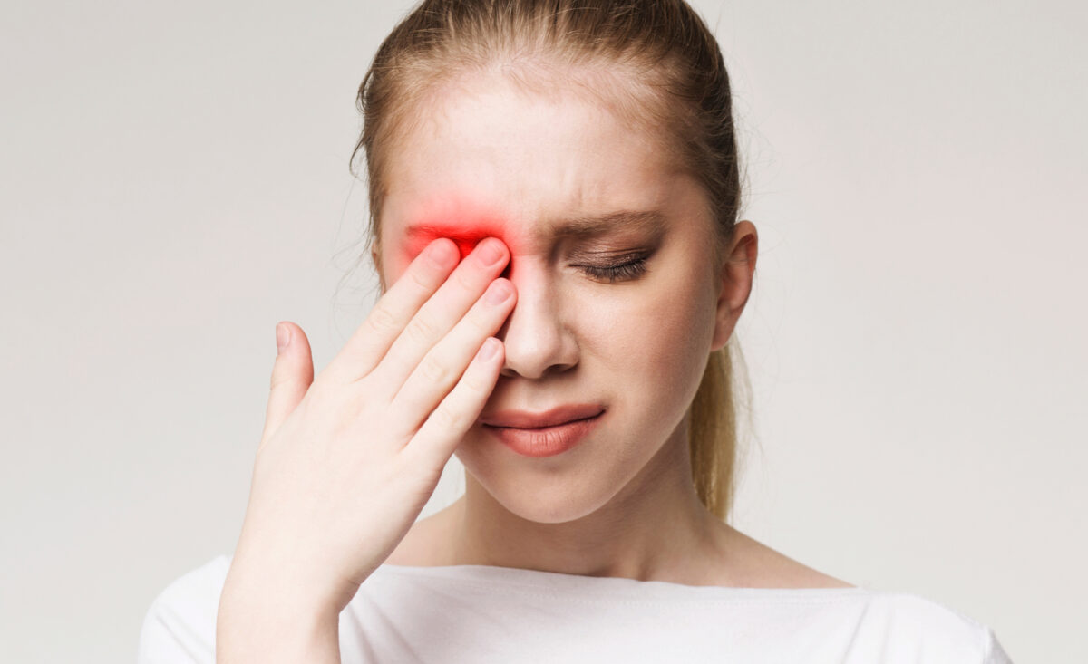 Upset woman suffering from eye pain