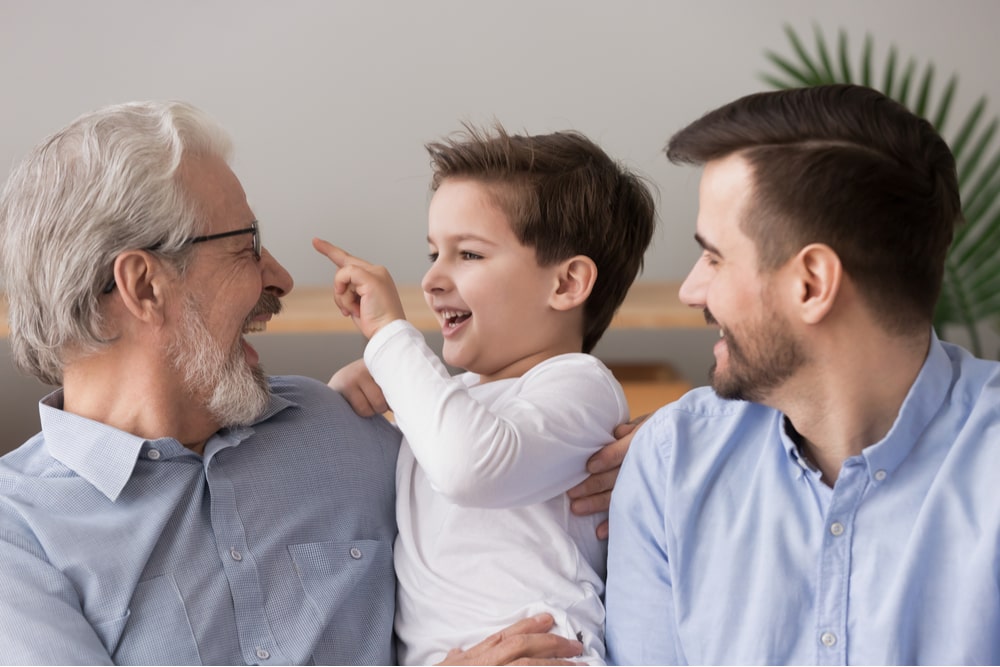 three generations of men having fun at home