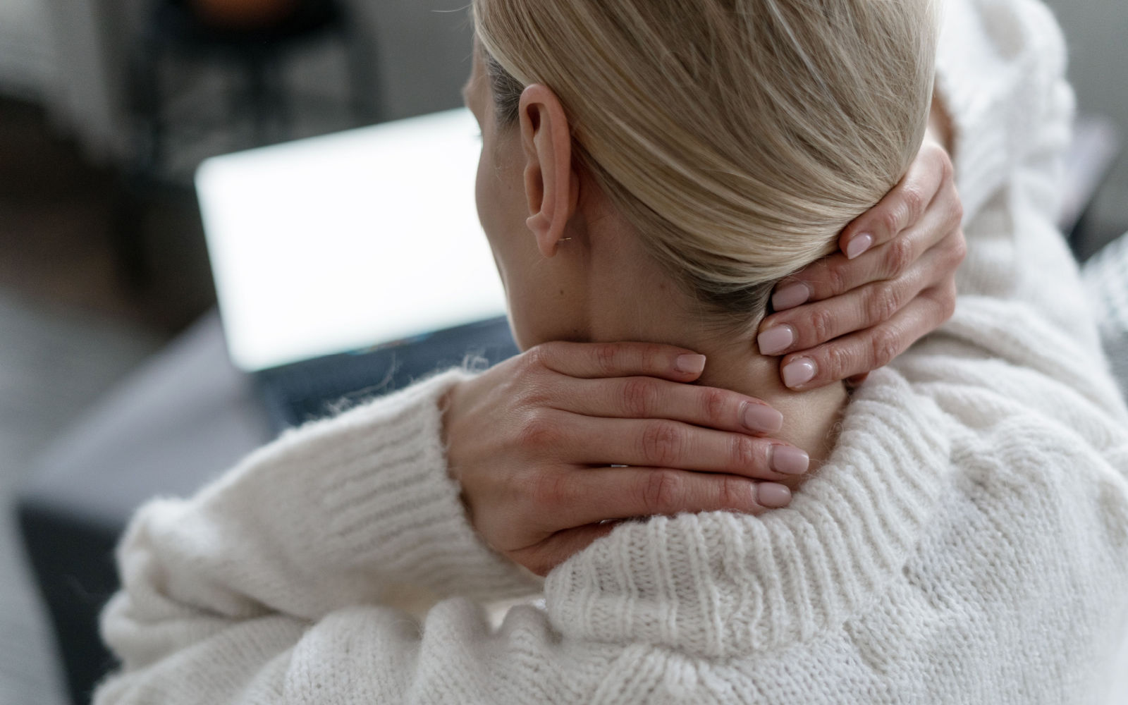 Woman Experiencing a Pinched Nerve Around Neck at Work