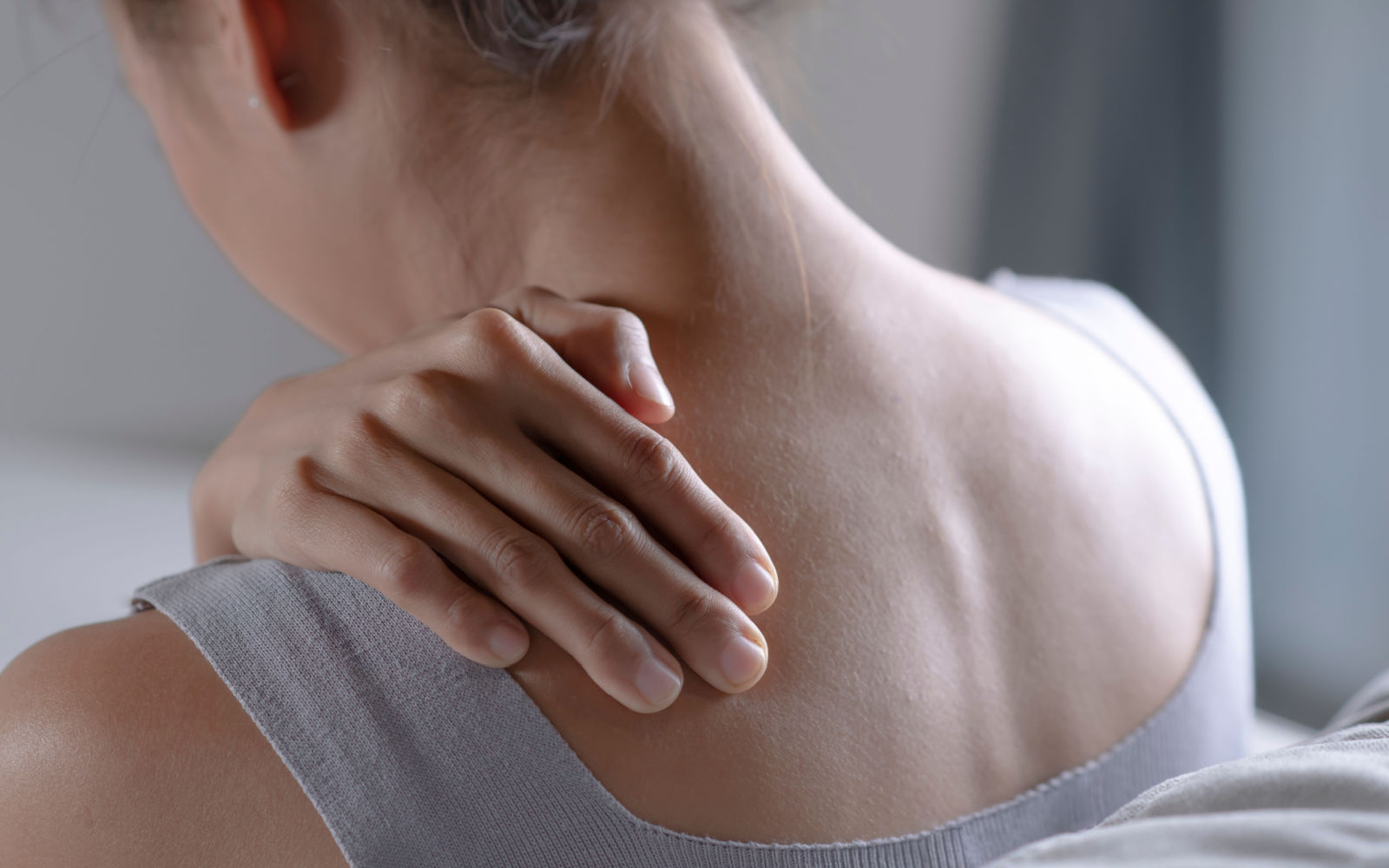 Woman experiencing Myofascial Pain Syndrome