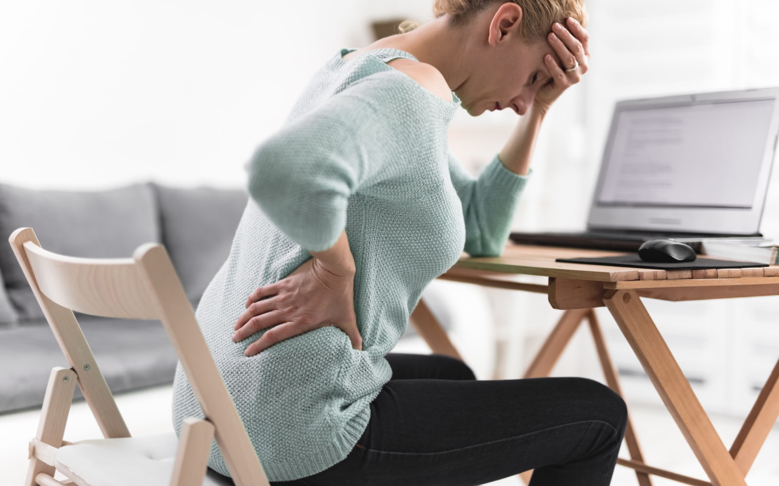 Woman Experiencing Hip Pain at Desk