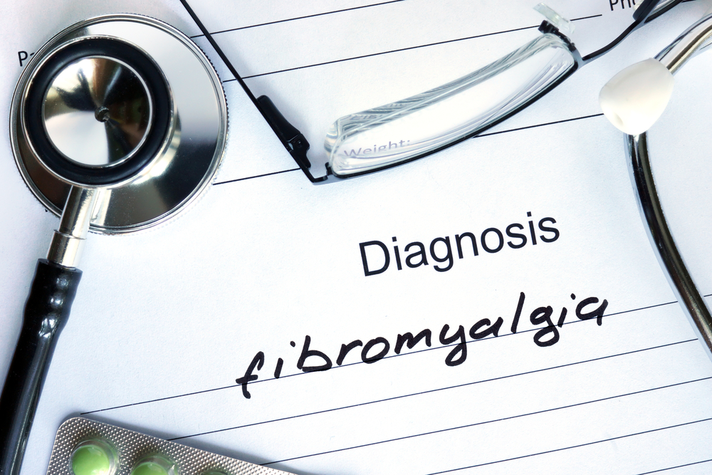 Form with diagnosis Fibromyalgia and tablets. Medical concept.