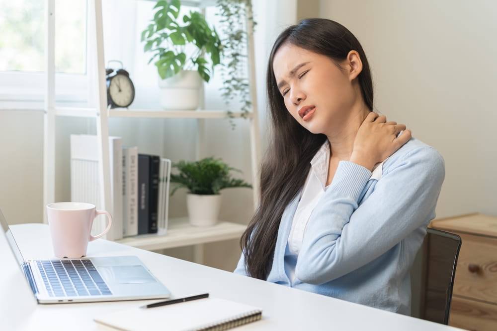 ache asian young woman, girl pain neck while sitting work on chair at home