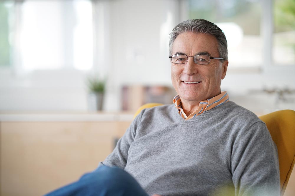 Smiling senior man with eyeglasses relaxing
