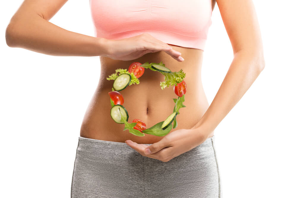 Circle of healthy foods on girls stomach