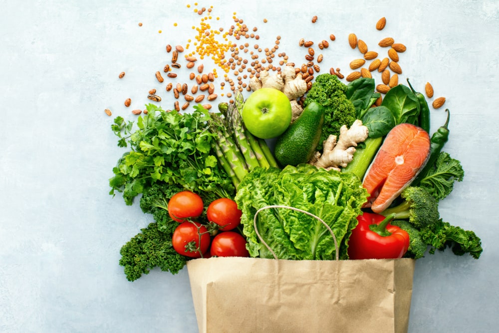 Top down view on a variety of fresh produce in a paper bag