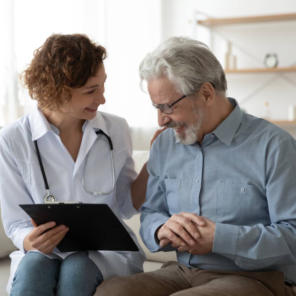 young female doctor with happy older senior man