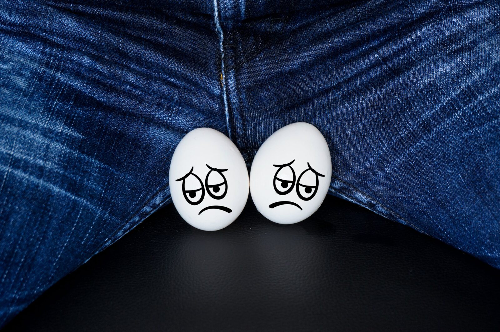 sad faces on white eggs - a symbol of testicles with the comic cartoon faces
