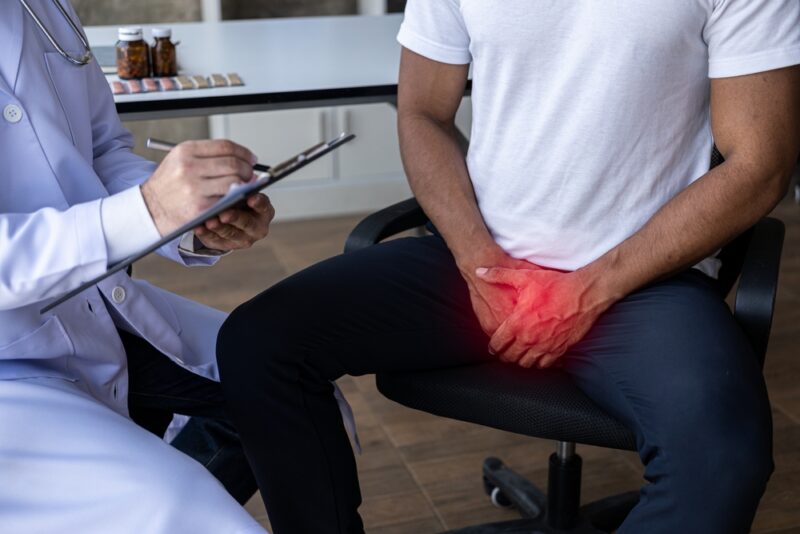 A man with an enlarged prostate examines and consults a doctor