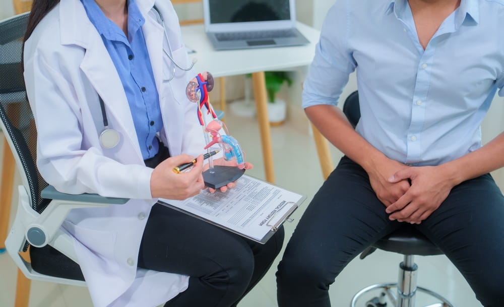 Female doctor treats Asian man with prostate gland, explains, examines, places to treat prostate gland