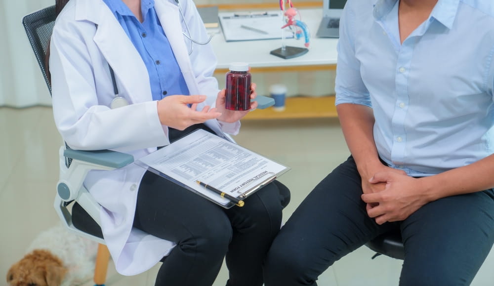 Young Asian man consults his doctor about the concept of enlarged prostate gland.