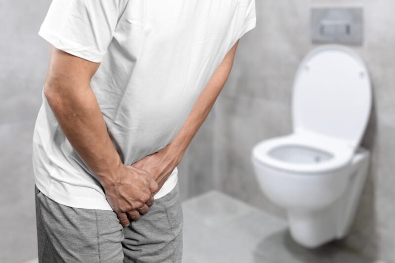 Person with urinary problems, Medical problem urinary incontinence. people with crotch pain, Man with hands on crotch with urinary problems