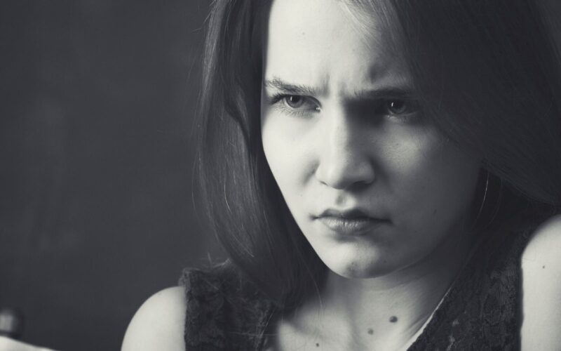 Woman Experiencing Anger Amid Grayscale Background