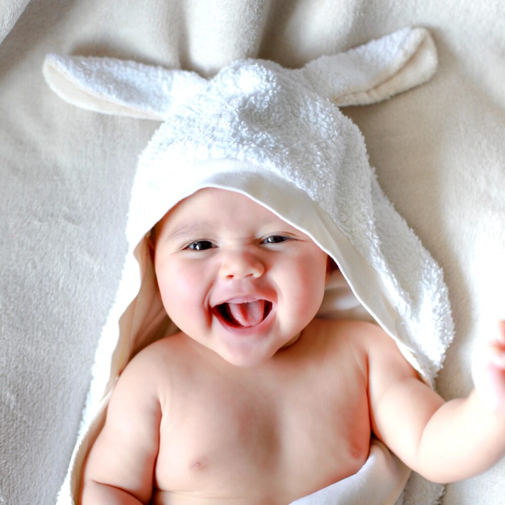 Adorable newborn baby wrap by white rabbit towel