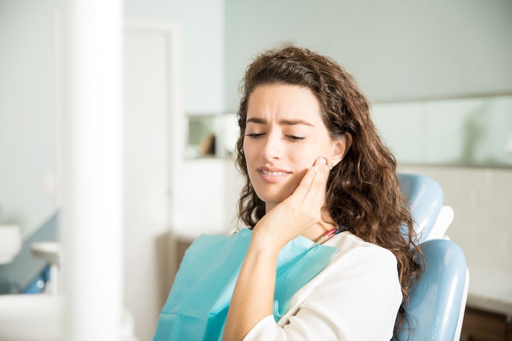 young woman suffering from toothache