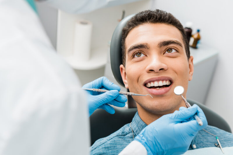 man with during examination in dental clinic
