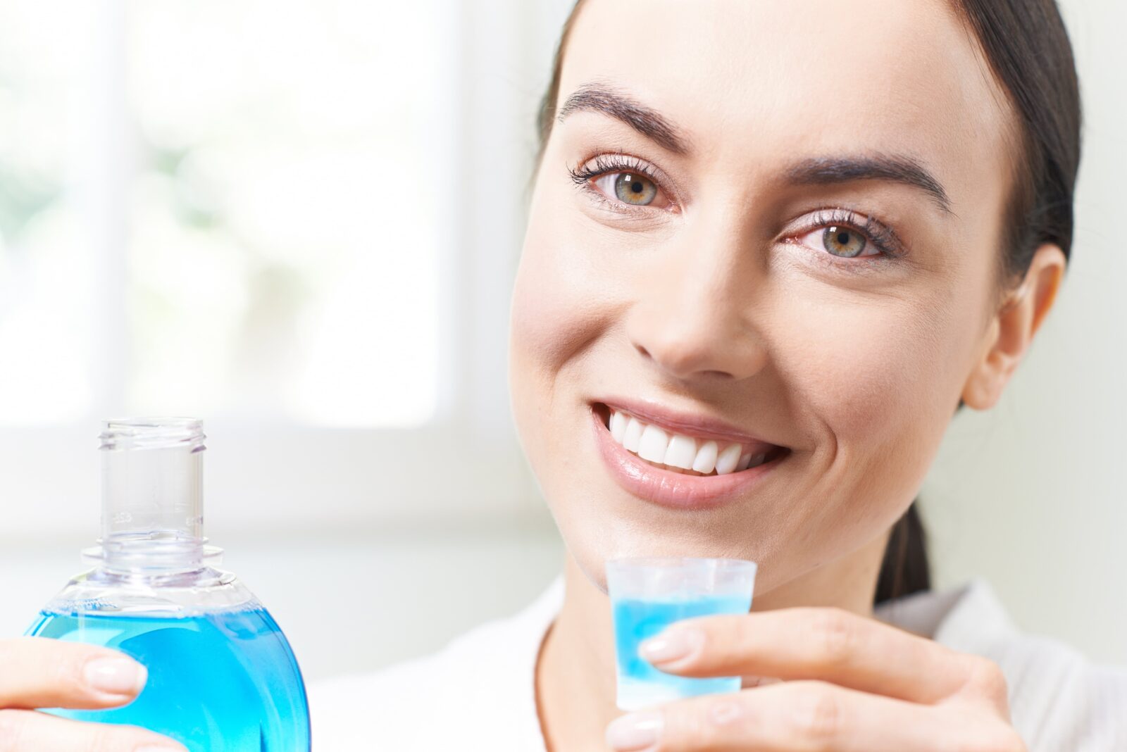woman using blue mouthwash