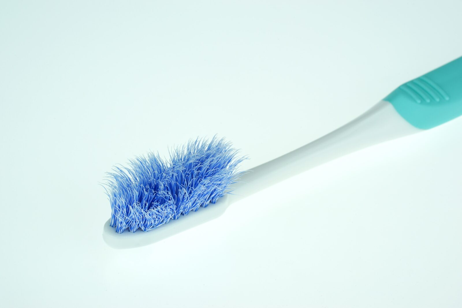old toothbrush with frayed bristles