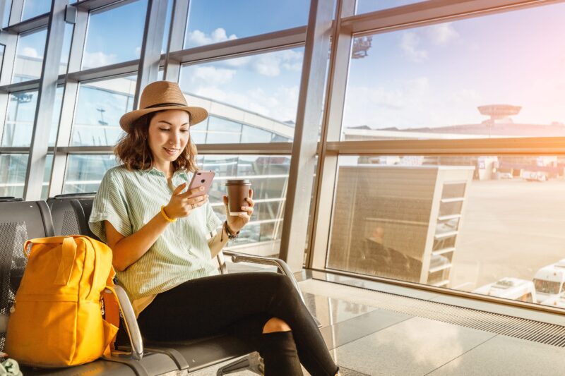woman sitting in airport by the window