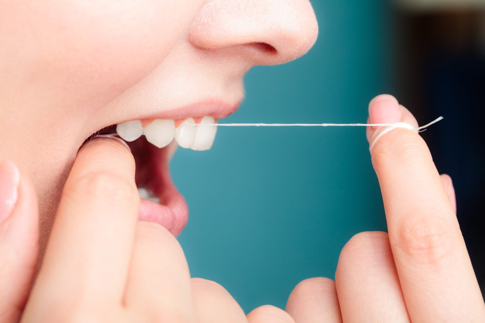side view of woman flossing
