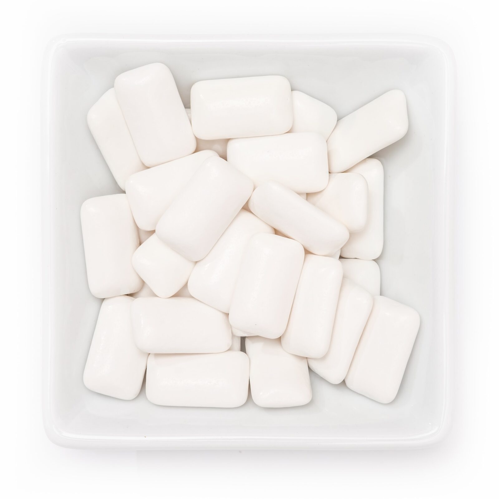 white sugar-free gum pieces in a bowl