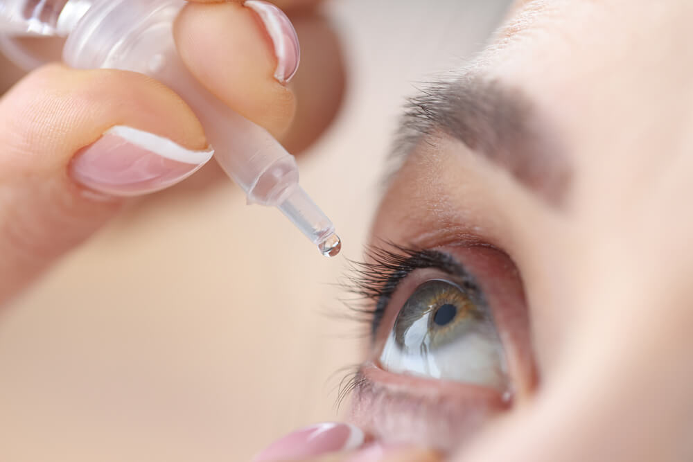 Woman drips eye drops