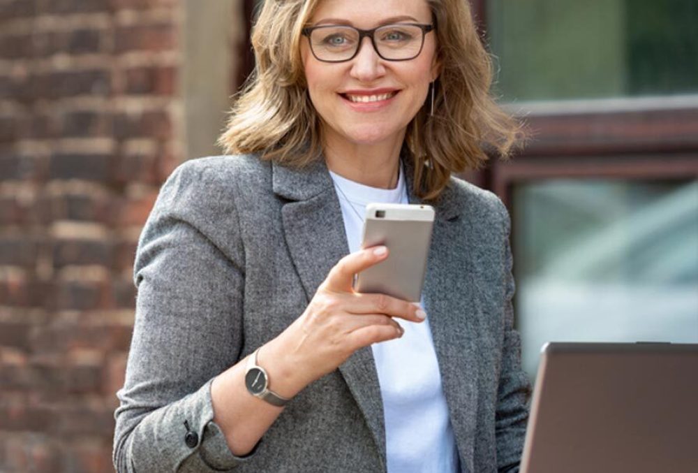 happy mature woman using her mobile phone