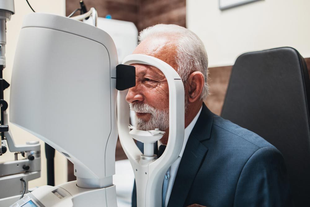 senior bearded man receiving ophthalmology treatment