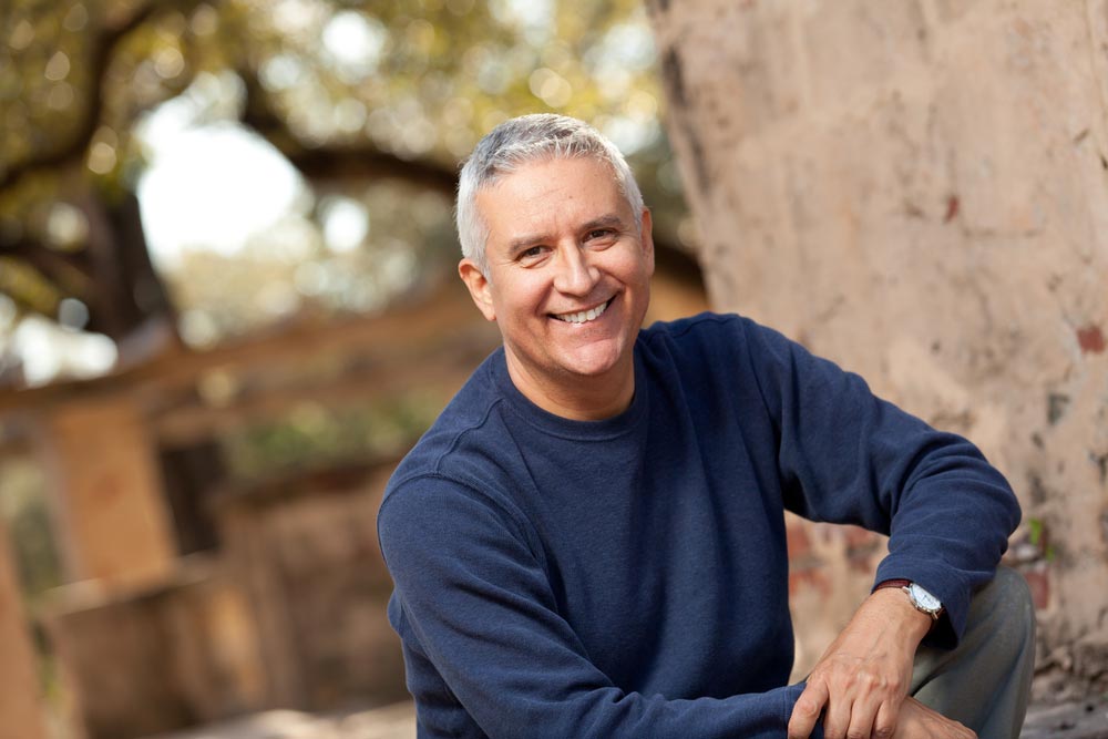 Handsome middle age man with gray hair in an outdoor setting