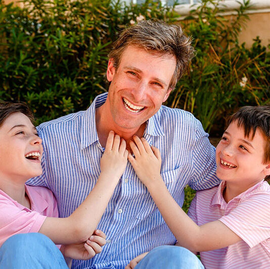 Young man smiling with Kids